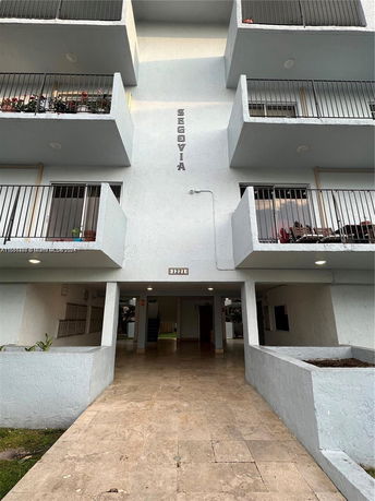 Front view of a multi-story building with balconies.