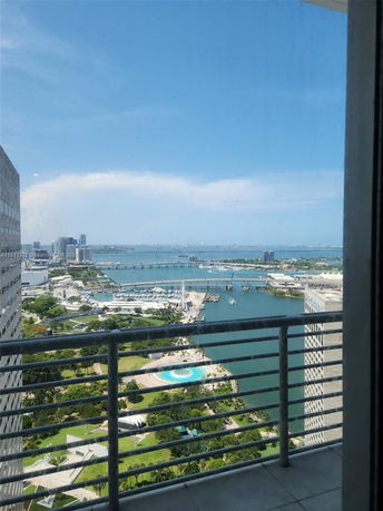 Wide-angle view of city skyline and water from a high-rise building.