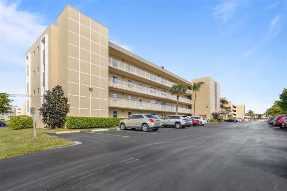Front view of a multi-story residential building with balconies.
