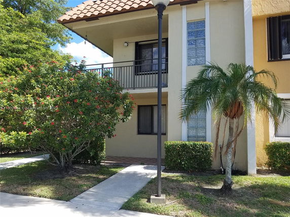 Front view of a two-story house with a balcony.