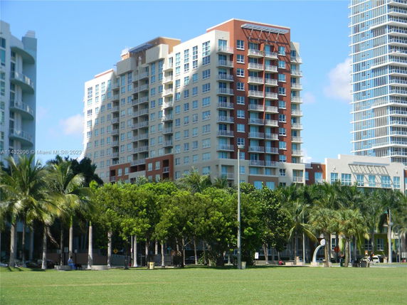 Front view of a multi-story residential building with balconies and modern architecture.