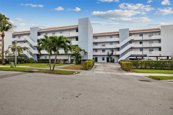Front view of a multi-story residential building with outdoor staircases.