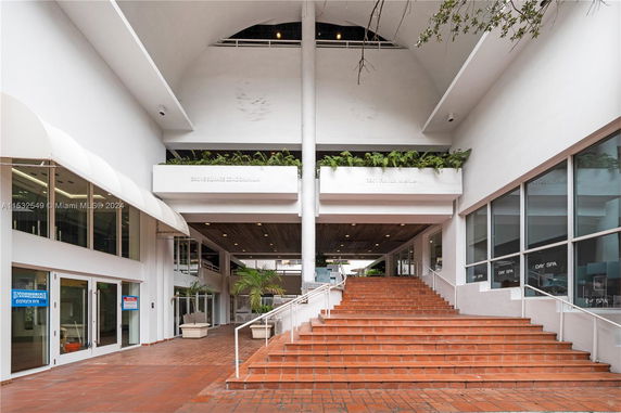 Entrance area of a condominium with stairs and planters.
