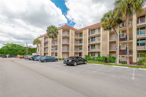 Front view of a multi-story apartment building with balconies.