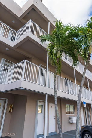 Front view of a multi-story building with balconies.