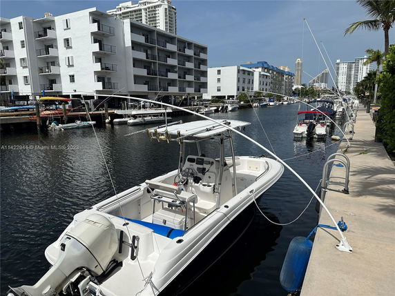 View of a waterfront area with boats docked alongside modern apartments.