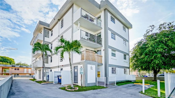 Front view of a multi-story residential building with balconies.