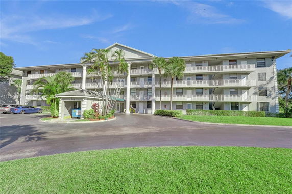 Front view of a multi-story residential building with balconies.