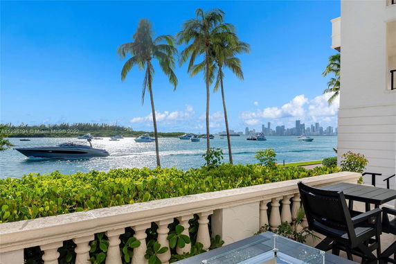 View from a balcony with a city skyline across the water.