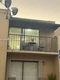 Front view of a two-story building with a balcony.