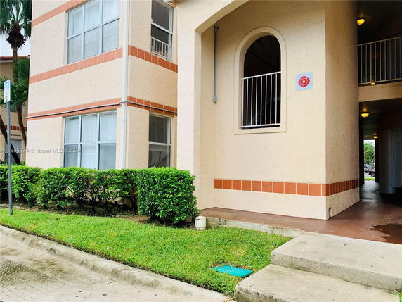 Front view of a multi-story building with arch window accents.