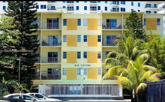 Front view of a multi-story apartment building with balconies.