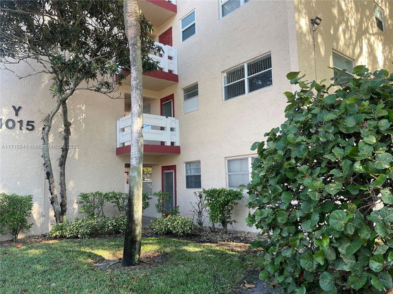 Front view of a multi-story building with balconies.