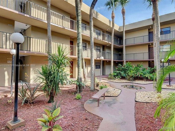 View of a multi-level building with balconies and landscaped courtyard.