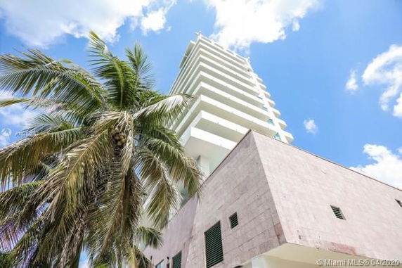 Front view of a modern multi-story building with balconies.