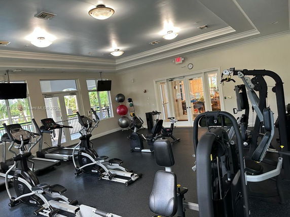 Interior view of a gym with exercise equipment and machines.