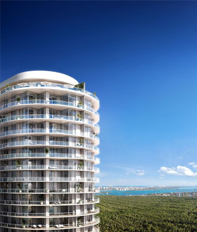Elevated view of a modern multi-story building with circular design elements and glass balconies.