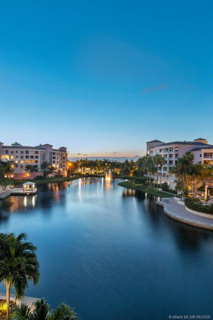 View of waterfront residential buildings at dusk.