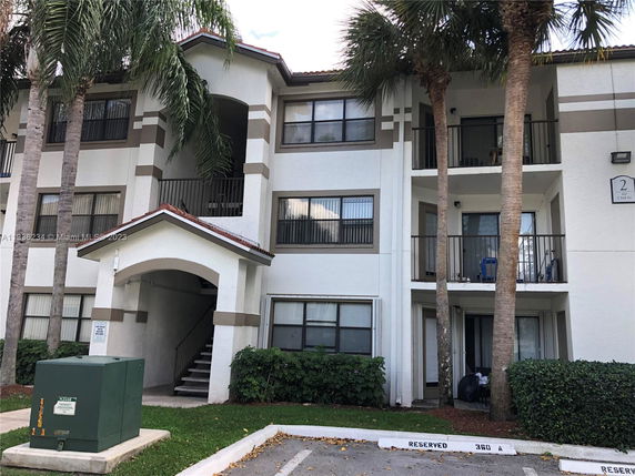 Front view of a multi-story residential building with balconies.