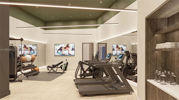 Interior view of a gym with treadmills, exercise equipment, and fitness balls.