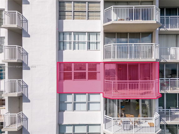 Front view of a multi-story building with balconies.