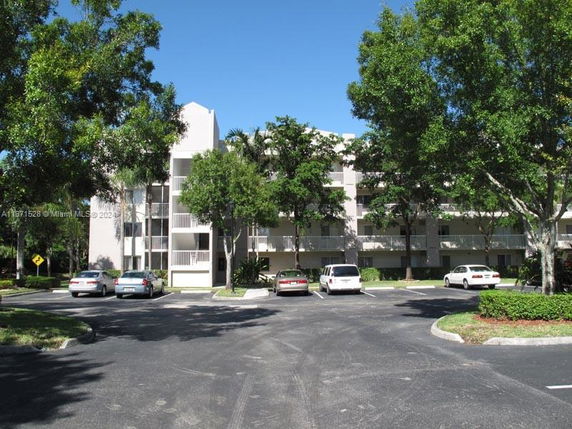 Front view of a multi-story residential building with balconies.