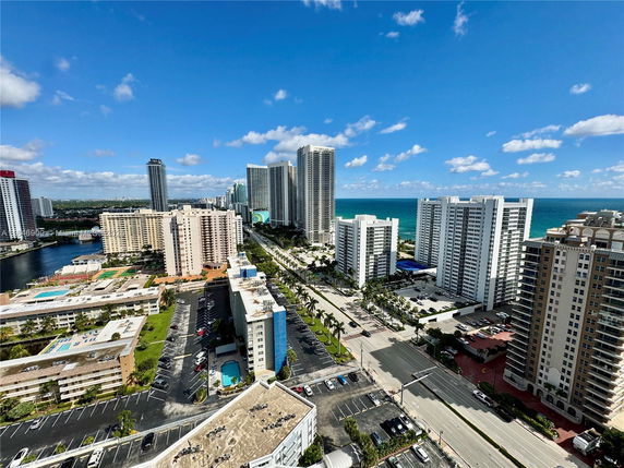 Panoramic view of high-rise buildings by the ocean.