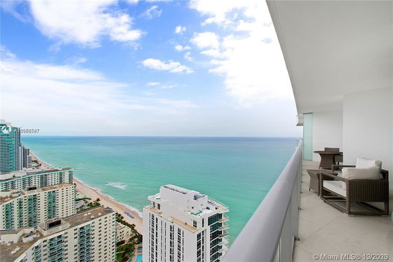 High-rise buildings and ocean view from a balcony.