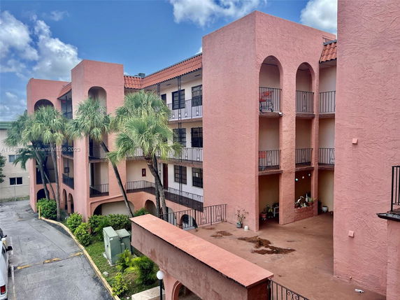 Front view of a multi-story residential building with balconies.