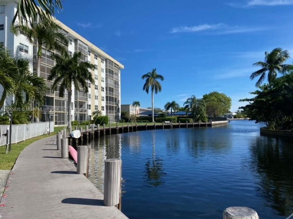 View of a multi-story residential building near a waterway.
