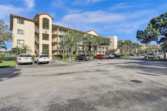 Front view of a multi-story residential building with balconies.