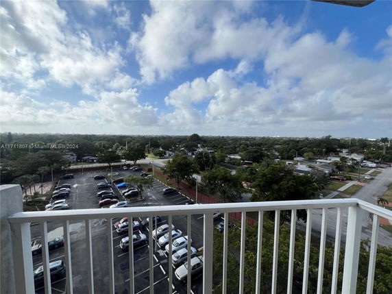 View of a parking area and residential neighborhood from a high vantage point.