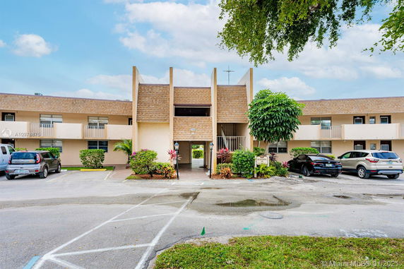 Front view of a two-story building with parking spaces.
