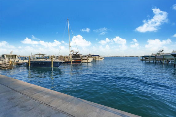 Waterfront view with boats docked at a marina pier.