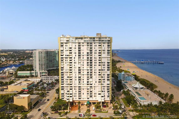 Front view of a high-rise building near a beach.