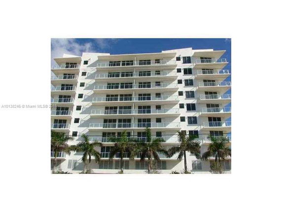Front view of a multi-story building with balconies.