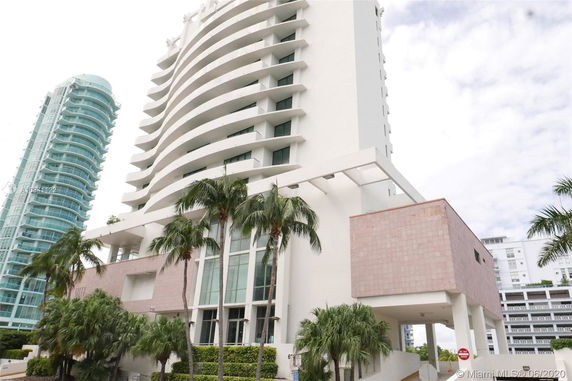 Front view of a modern multi-story building with curved balconies.