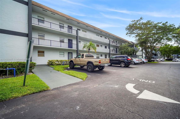 Multi-story building with parking area.