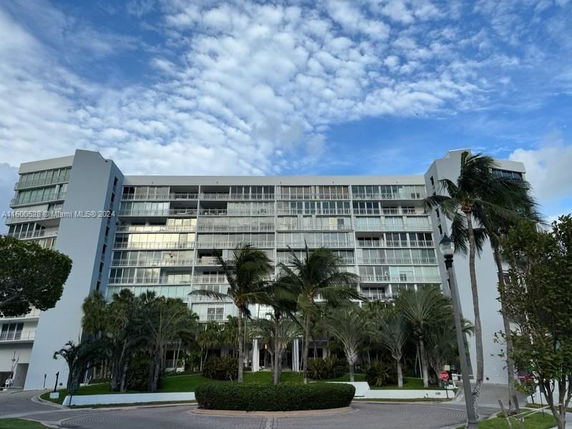 Front view of a multi-story apartment building with balconies.