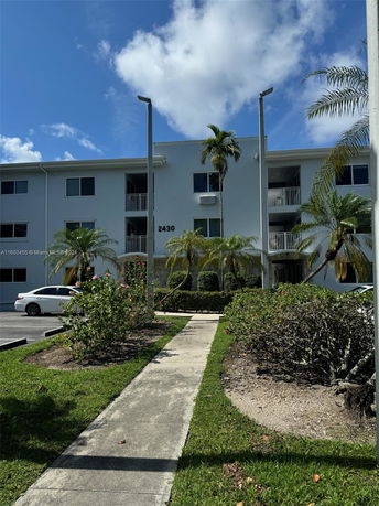 Front view of a three-story residential building with balconies.