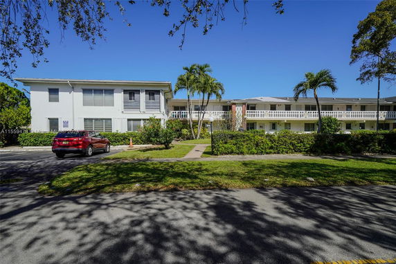 Front view of a multi-story residential building with balconies.
