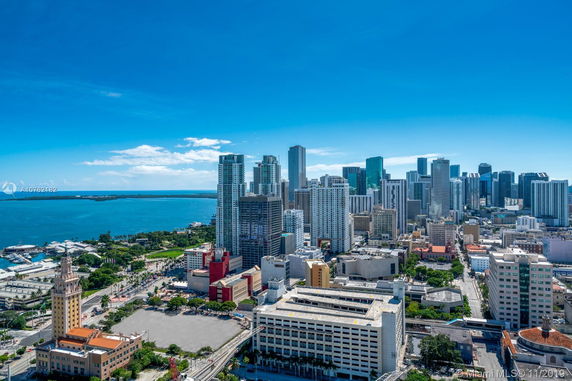 Panoramic view of a city skyline with high-rise buildings near the waterfront.