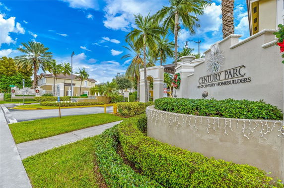 Entrance view of a gated community with a sign for Century Parc.