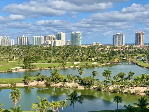 Panoramic view of a landscape with high-rise buildings and green spaces.