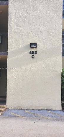 Front view of a multi-story building with visible number and letter 483 C.