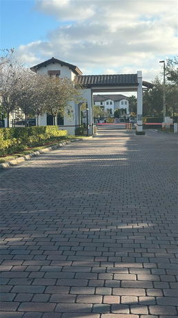 Front view of a building entrance with a gated archway.