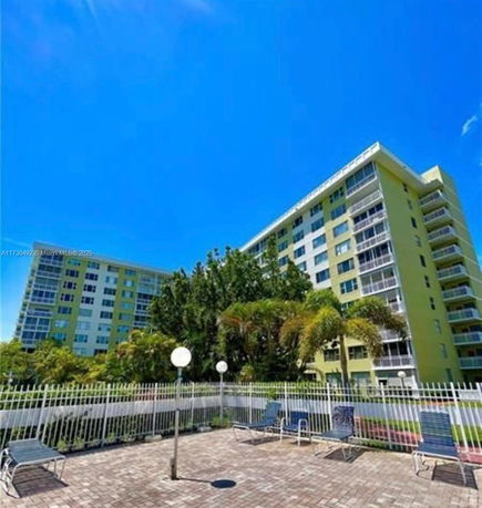Front view of a multi-story residential building with balconies.