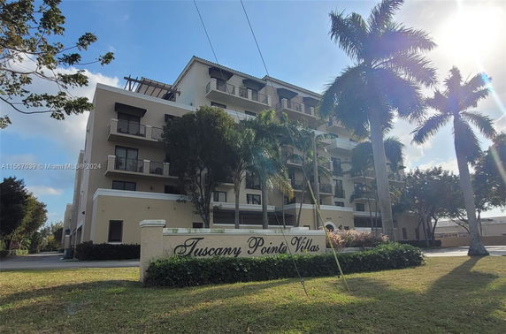 Front view of a multi-story residential building named Tuscany Pointe Villas.