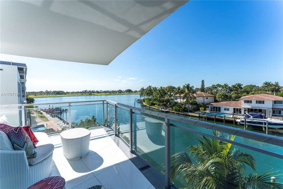 Balcony view overlooking waterfront houses and a waterway.
