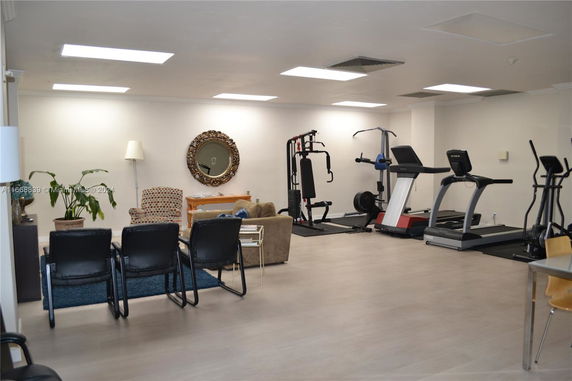 Indoor area with gym equipment and seating arrangement.